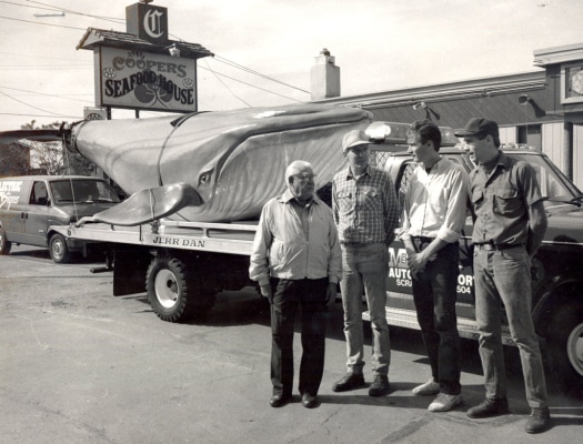 TIMES-SHAMROCK ARCHIVES Owners of Cooper’s Seafood House — from left, John, Paul, Jack and Matthew Cooper — take their new centerpiece, a 26-foot-long, 1,000 pound Styrofoam blue whale, out for a drive on Oct. 13, 1986. Electric City Signs of North Scranton crafted the faux mammal to hang in Cooper’s new dining room.
